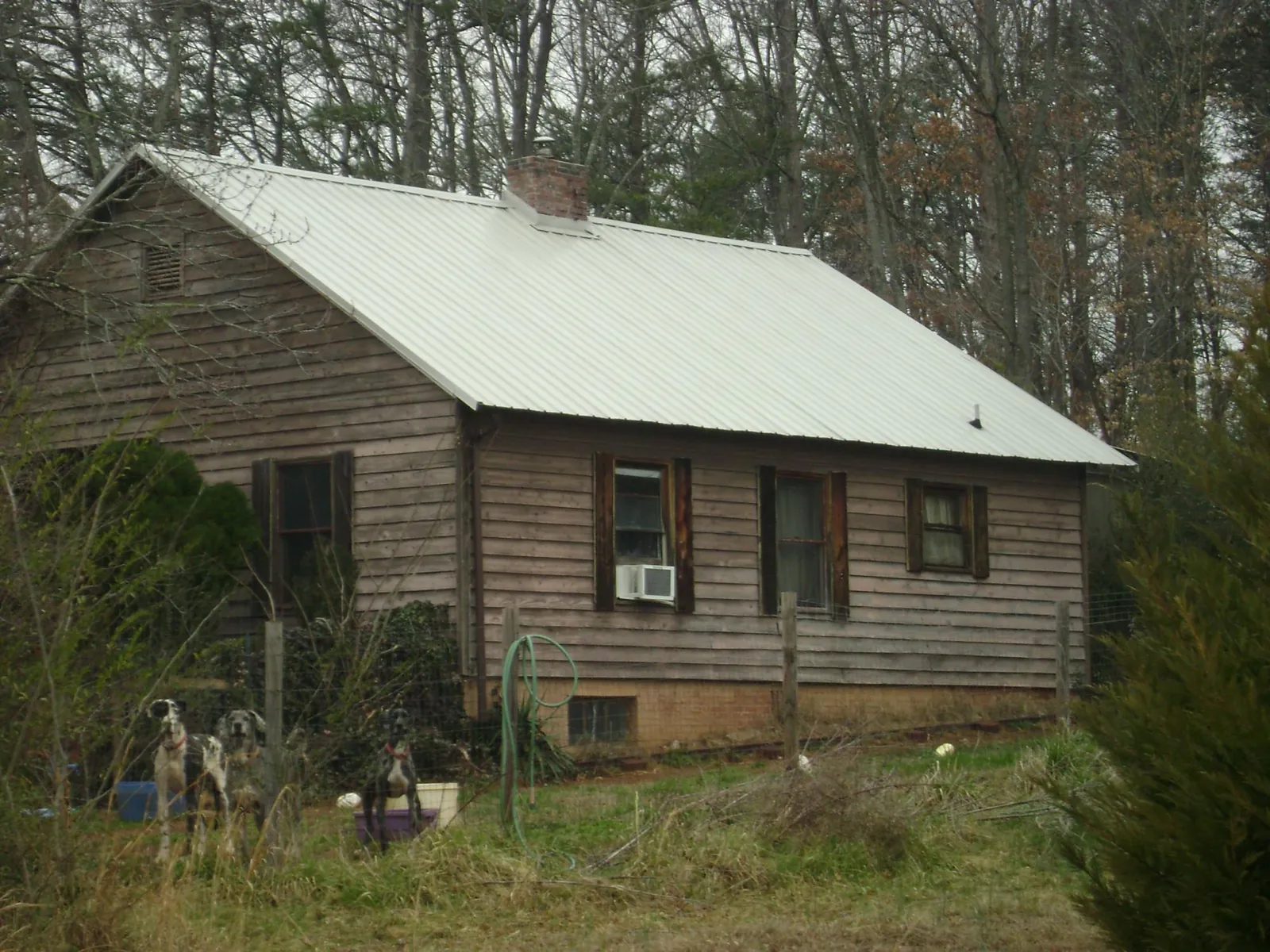White metal roof on an old wood sided farmhouse, from a Metal Roof Installation job in Silver Springs